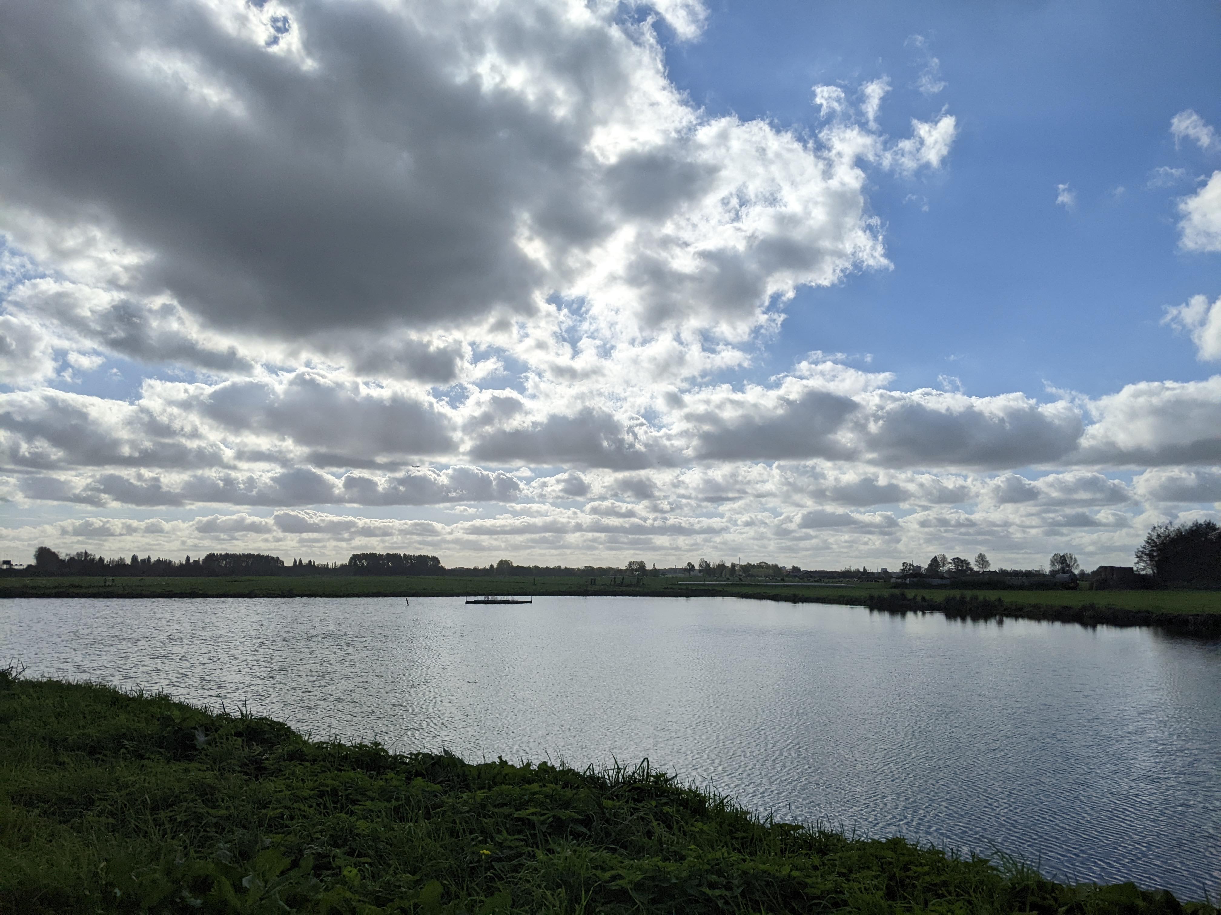 A body of water with an airplane taking off