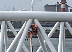 zoomed in crop of tiny people against huge structure